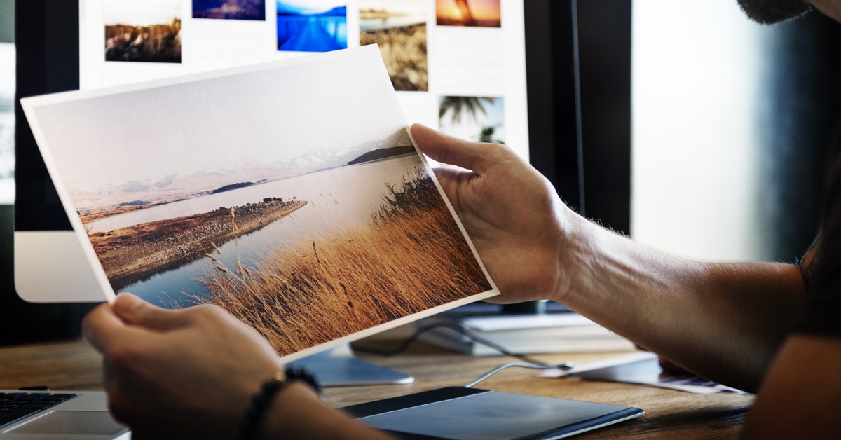 Person holding picture of river