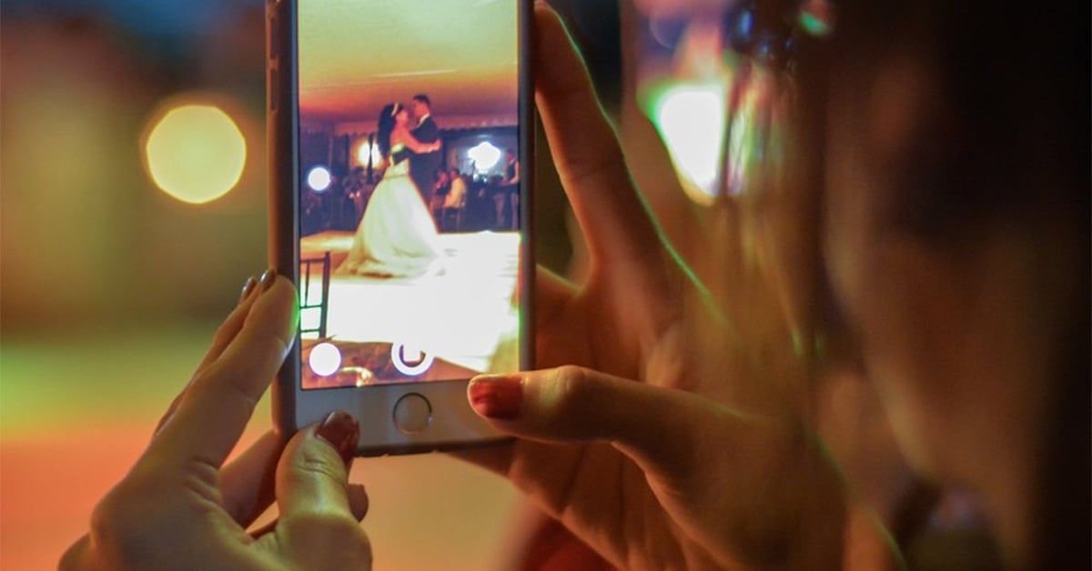 woman filming a wedding from phone