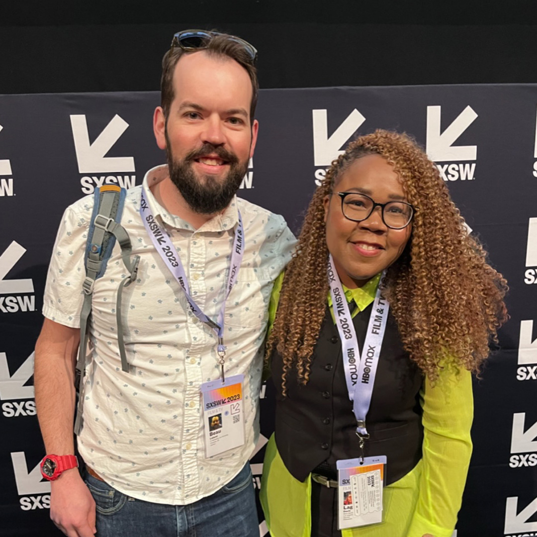 Two friends smile at the camera at the South by Southwest Film Festival.