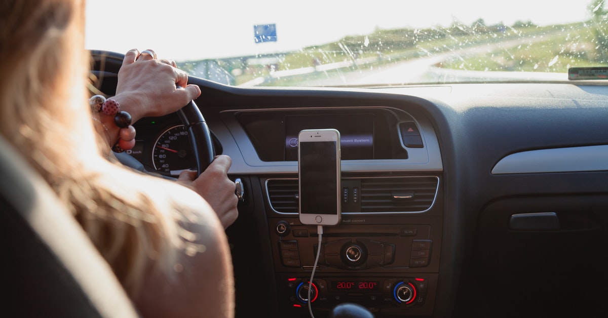 girl driving by billboard