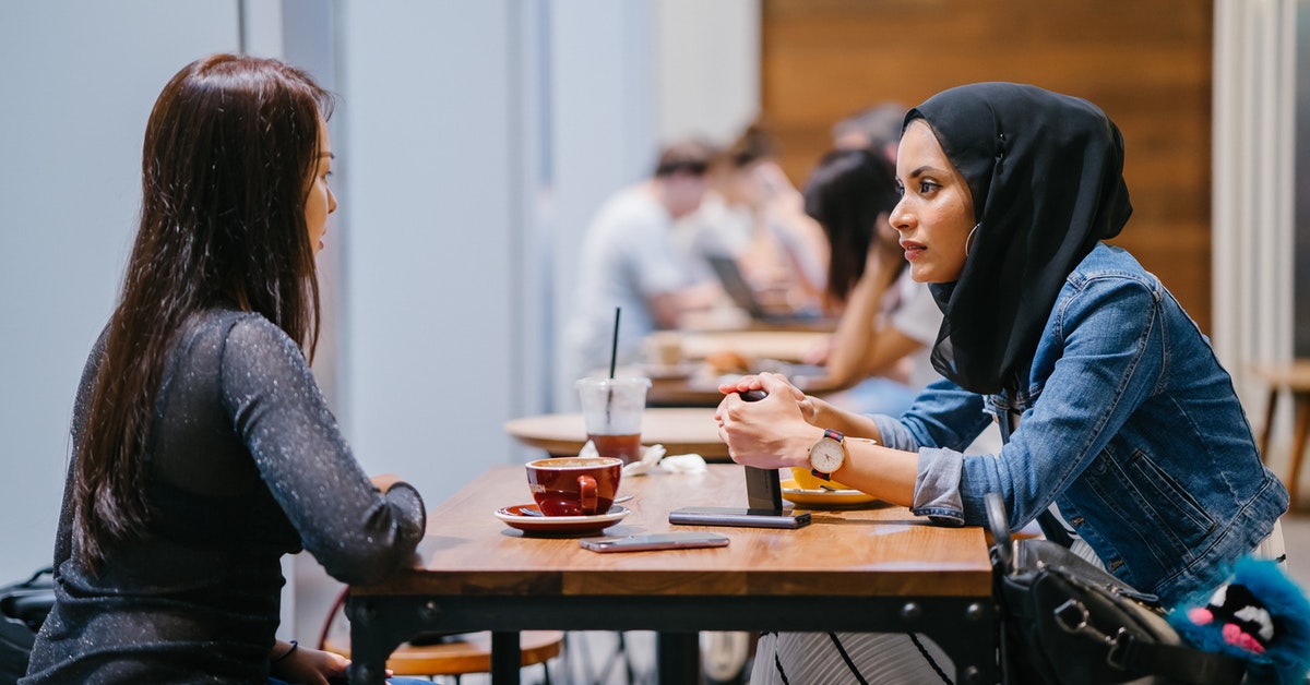 Two friends talking over coffee